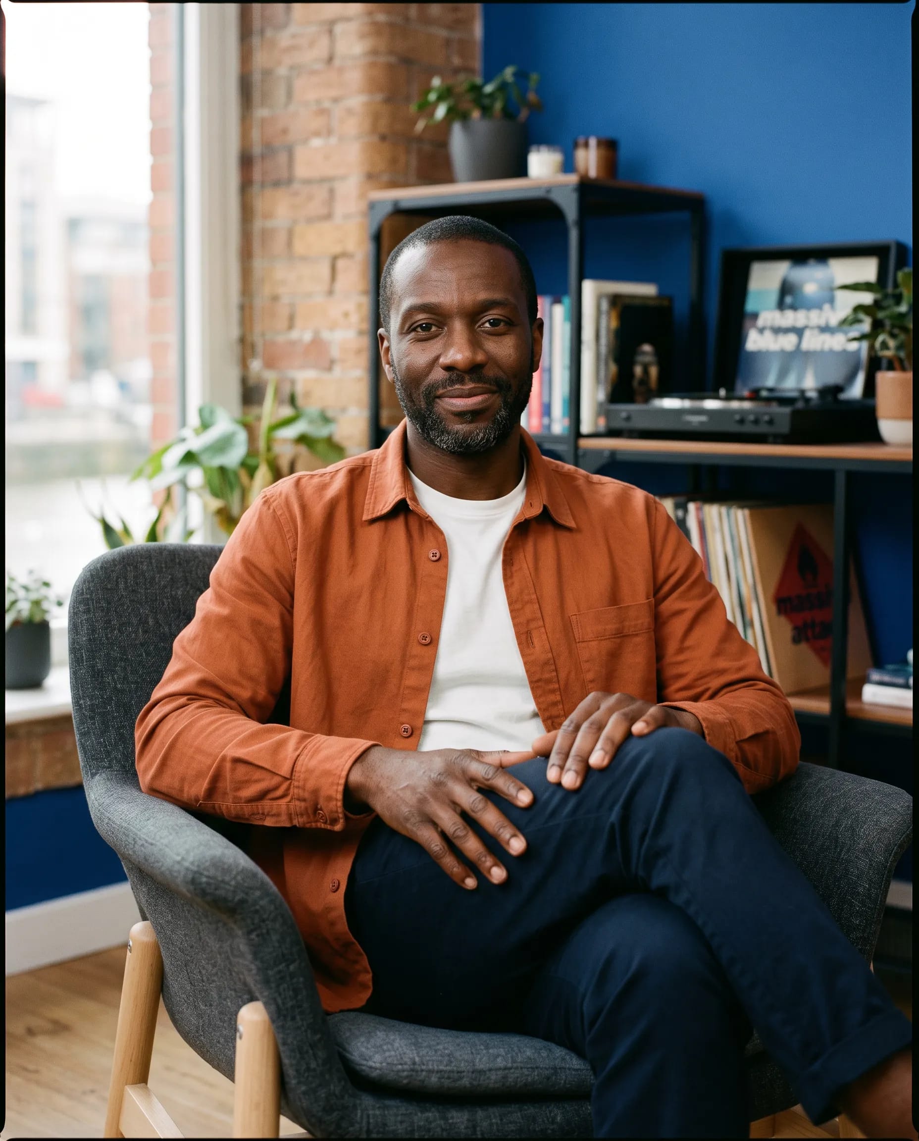 Marcus Grant, psychotherapist, seated in his Bristol practice room with a dry smile