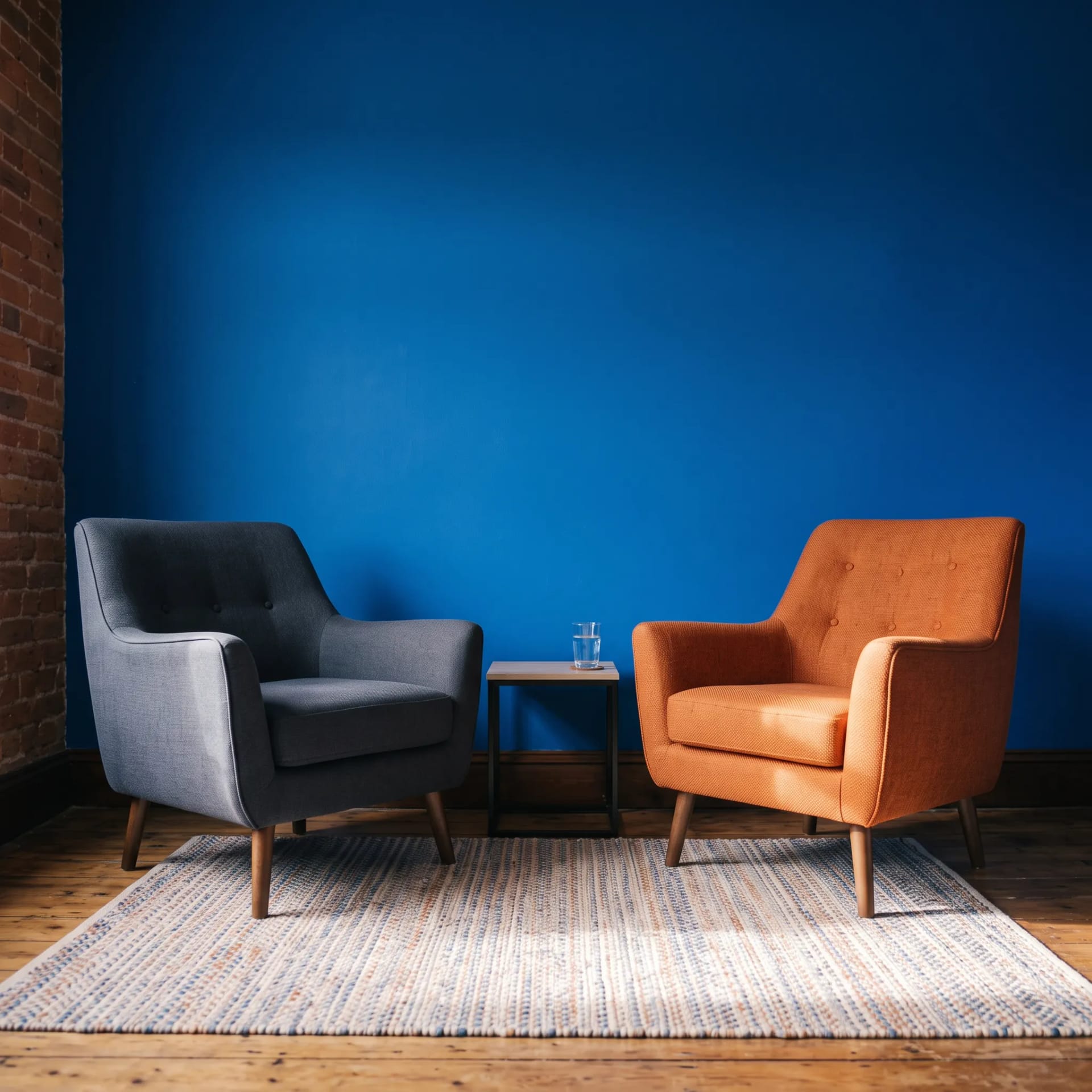 Two chairs facing each other in the bold cobalt practice room at Straight Up Therapy, Bristol